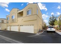 Two-story home featuring multiple garages, and a light beige color scheme on a sunny day at 6317 Beige Bluff St # 3, North Las Vegas, NV 89081