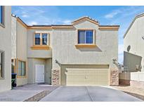 Two-story home with a two-car garage and stucco exterior, accented by stone veneer on the garage's corners at 6329 Aloha Sue St, North Las Vegas, NV 89031