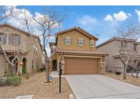 Two-story home features a tile roof, a two-car garage, and desert landscaping at 8683 Bella Jewel Ave, Las Vegas, NV 89178