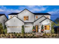 Stunning two-story home featuring a modern farmhouse design with a well-manicured front yard and a three-car garage at 10131 Sequoia Glen Ave, Las Vegas, NV 89166