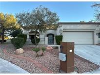 Charming single-story home featuring a desert landscape and an attached two-car garage at 10301 Broom Hill Dr, Las Vegas, NV 89134