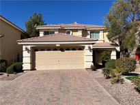 Charming two-story home with a two car garage and beautifully landscaped front yard at 11009 Royal Highlands St, Las Vegas, NV 89141