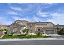 Beautiful home featuring a well-manicured lawn, stone accents, and a spacious three-car garage at 1320 Enchanted River Dr, Henderson, NV 89012