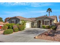 Charming single-story home with a well-manicured front yard and a two car garage at 1372 Coppelia Ct, Henderson, NV 89052