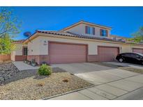 Inviting townhome with a two-car garage and desert landscaping for easy maintenance at 1435 Orange Jubilee Rd, Henderson, NV 89014