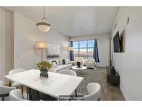 Bright living room featuring neutral decor, modern furniture and a large window with mountain views at 150 Las Vegas Blvd # 818, Las Vegas, NV 89101