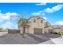 Charming two-story home featuring a two-car garage, landscaped front yard and brick steps at 2865 Victorian Rd, North Las Vegas, NV 89086