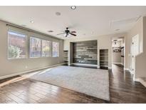 Bright living room features large windows, ceiling fan, shelving, and accent wall at 336 S Milan St, Henderson, NV 89015
