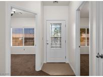 Inviting entryway featuring a decorative glass front door and views into adjacent carpeted rooms with natural light at 341 Grapevine Rd, Mesquite, NV 89027