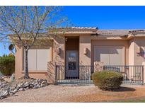 Charming home featuring a cozy front porch with a decorative rock garden and desert landscaping at 341 Grapevine Rd, Mesquite, NV 89027