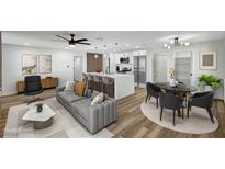 A bright and open living room and kitchen combo featuring stylish decor and modern appliances at 4804 El Tesoro Ave, Las Vegas, NV 89121