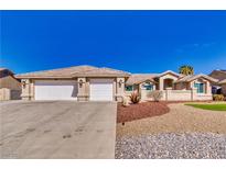 Charming single-story home featuring a three-car garage and well-maintained desert landscaping at 5090 Balhurst Ct, Pahrump, NV 89061