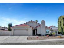 Charming single-story home featuring a desert landscaped yard, red tile roof, and attached two-car garage at 602 Paloma Dr, Boulder City, NV 89005