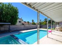 Relaxing pool area with shimmering blue water and a covered patio perfect for entertaining at 6149 Vista Verde, Las Vegas, NV 89146