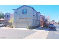 Two-story home with a two-car garage and manicured landscaping, offering curb appeal and convenience at 8957 Rufina St, Las Vegas, NV 89148