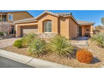 Charming single-story home featuring desert landscaping, a tiled roof, and an inviting front entrance at 9076 Bridal Creek Ave, Las Vegas, NV 89178
