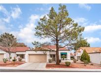 Charming single-story home featuring a red tile roof and mature landscaping at 9308 Quail Ridge Dr, Las Vegas, NV 89134