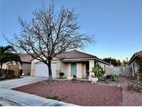 Charming single-story home featuring a landscaped front yard and a two-car garage at 9378 Spellman Ct, Las Vegas, NV 89123