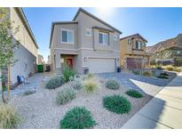 Charming two-story home boasts desert landscaping, a paver driveway, and a welcoming red front door at 10785 Wild Parsley Ave, Las Vegas, NV 89129