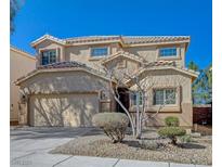 Charming two-story home with desert landscaping, tile roof, and two-car garage at 1163 Tumbling River Ave, Henderson, NV 89052