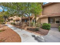 Charming condo exterior with stucco walls, tile roof, and mature landscaping along the walkway at 3383 Pavlo St, Las Vegas, NV 89121