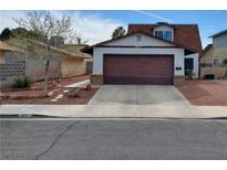 Charming home featuring a two-car garage, a cozy front yard, and an inviting entrance at 6717 Sheffield Dr, Las Vegas, NV 89108