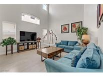 Bright living room with high ceilings, modern furniture, and plenty of natural light at 6938 Silk Oak Ct, Las Vegas, NV 89148