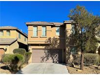 Two-story home with a two car garage and desert landscaping at 8558 Rumsfield Ct, Las Vegas, NV 89131