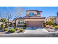 Charming two-story home featuring a well-manicured front yard with lush landscaping at 11773 Golden Moments Ave, Las Vegas, NV 89138