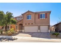 Charming two-story home boasts a three-car garage and desert landscaping at 1033 Via Dell Bacio Dr, Henderson, NV 89052