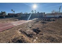 Wide angle of the home's front yard with a bright, sunny sky at 1275 Westwind Rd, Las Vegas, NV 89146