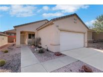 Charming single-story home featuring a two-car garage, low maintenance desert landscaping, and a welcoming front entry at 2201 Tiger Links Dr, Henderson, NV 89012