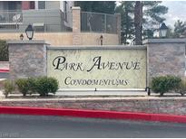 Park Avenue Condominiums building sign with brick accents and lush green landscaping at 27 E Agate Ave # 303, Las Vegas, NV 89123