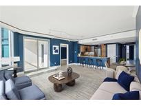 Open-concept living room with a modern kitchen, balcony access, and stylish contemporary furnishings at 322 Karen Ave # 2501, Las Vegas, NV 89109
