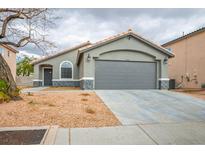 Charming single story home with a two car garage, desert landscaping, and neutral paint at 3334 Flying Colt Ct, North Las Vegas, NV 89032