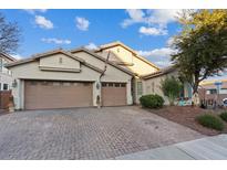 Charming single-story home with desert landscaping, two-car garage, and brick paved driveway at 6944 Puetollano Dr, North Las Vegas, NV 89084