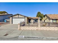 Charming single-story home featuring a two-car garage and decorative front yard fence at 7176 Southpark Ct, Las Vegas, NV 89147