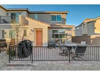 Cozy backyard patio with outdoor seating and a grill, perfect for entertaining and relaxing outdoors at 2657 Fawn Beige Ct, North Las Vegas, NV 89086