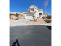 Charming two-story home with stucco exterior, desert landscaping, and a two-car garage at 3304 Michelangelo Ct, Las Vegas, NV 89129