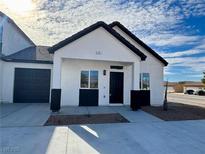 Charming single-story home with a modern black-and-white color scheme and an attached garage at 376 E Erin St # 1, Pahrump, NV 89048