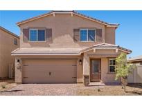 Charming two-story home featuring a brick driveway and a tan exterior at 6773 Violet Cascade Ave, Las Vegas, NV 89156