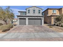 Two-story home featuring a two-car garage and brick driveway at 6832 Upland Heights Ave, Las Vegas, NV 89142