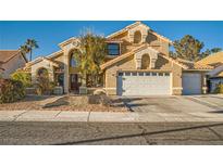 Charming two-story home featuring a neutral stucco finish, tile roof, and a well-manicured front yard at 9532 Cliff View Way, Las Vegas, NV 89117