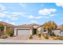 Charming single-story home with stone accents, a tile roof, and a well-manicured front yard at 10438 Skye Arroyo Ave, Las Vegas, NV 89166