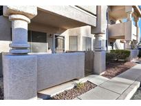 Charming condo exterior with a gated front porch and stucco facade at 1316 Driscoll Dr # 102, Las Vegas, NV 89128