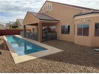 Stunning backyard pool with covered patio and low-maintenance desert landscaping at 172 Turtle Ridge Ave, Las Vegas, NV 89183