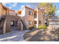 Inviting exterior of a multi-story condo building showcasing the architecture and well-maintained landscaping at 1851 Hillpointe Rd # 2912, Henderson, NV 89074