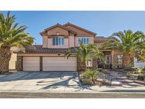 Beautiful two-story home featuring a three-car garage, tile roof, and desert landscaping at 2529 Vera Cruz Cir, Henderson, NV 89074