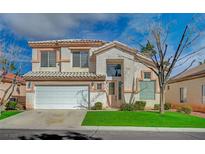 Inviting two-story home featuring a well-maintained lawn, white garage door, and neutral stucco exterior at 316 Blackstone River Ave, Las Vegas, NV 89148