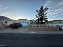Charming single-Gathering home featuring desert landscaping and a well-maintained front yard at 446 Tiger Lily Way, Henderson, NV 89015